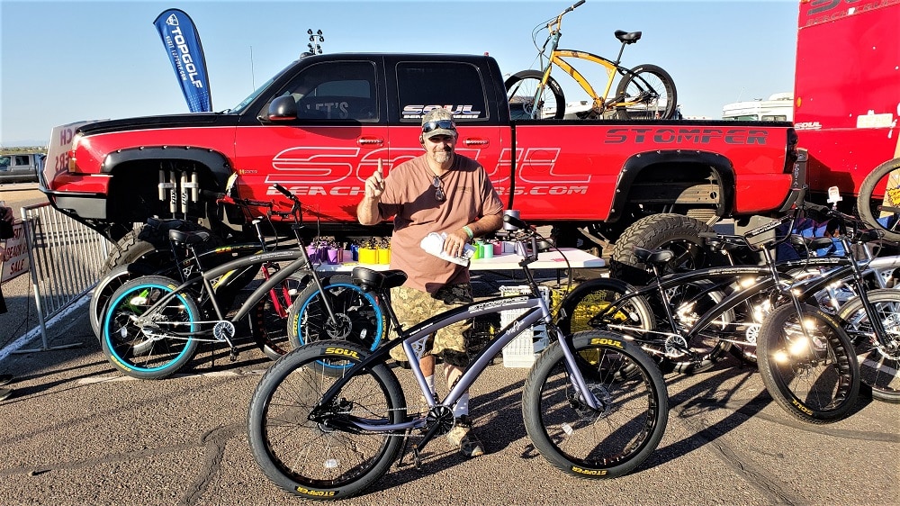 A man near bikes and a large pickup truck