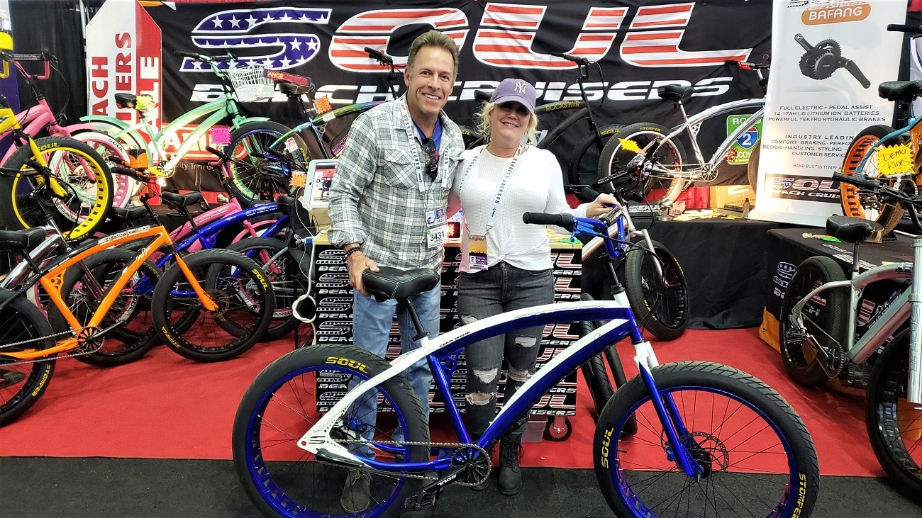 A man and a woman holding a bike