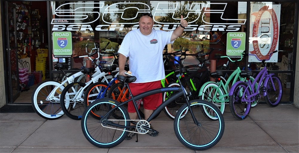 A happy man showing a thumbs up for his new bike